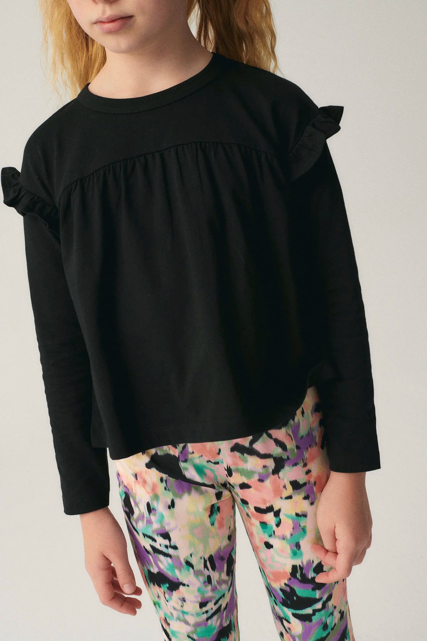 Girl's top with black ruffles
