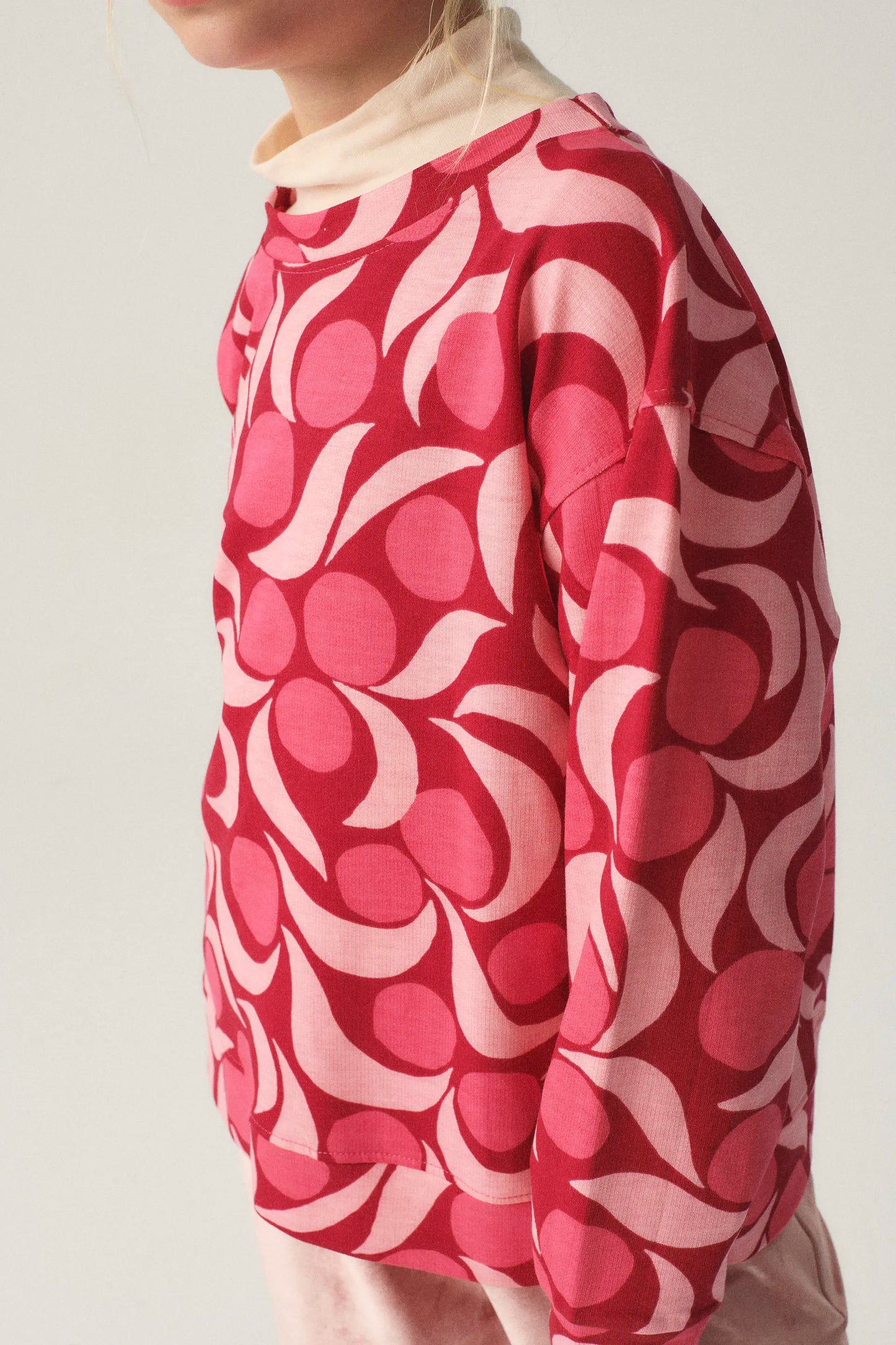 Unisex plush sweatshirt with pink fantasy print
