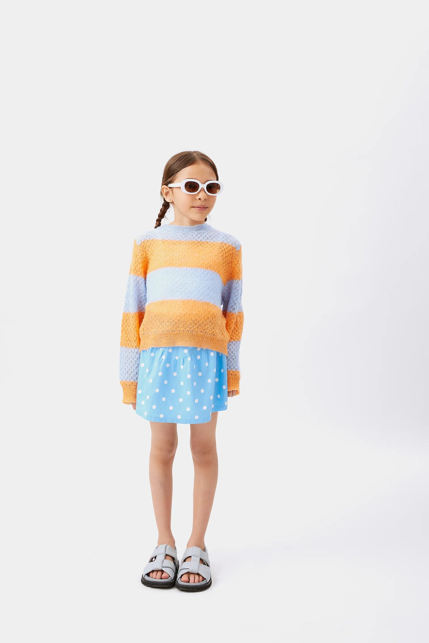 Maglione da bambina lavorato a trecce a righe blu