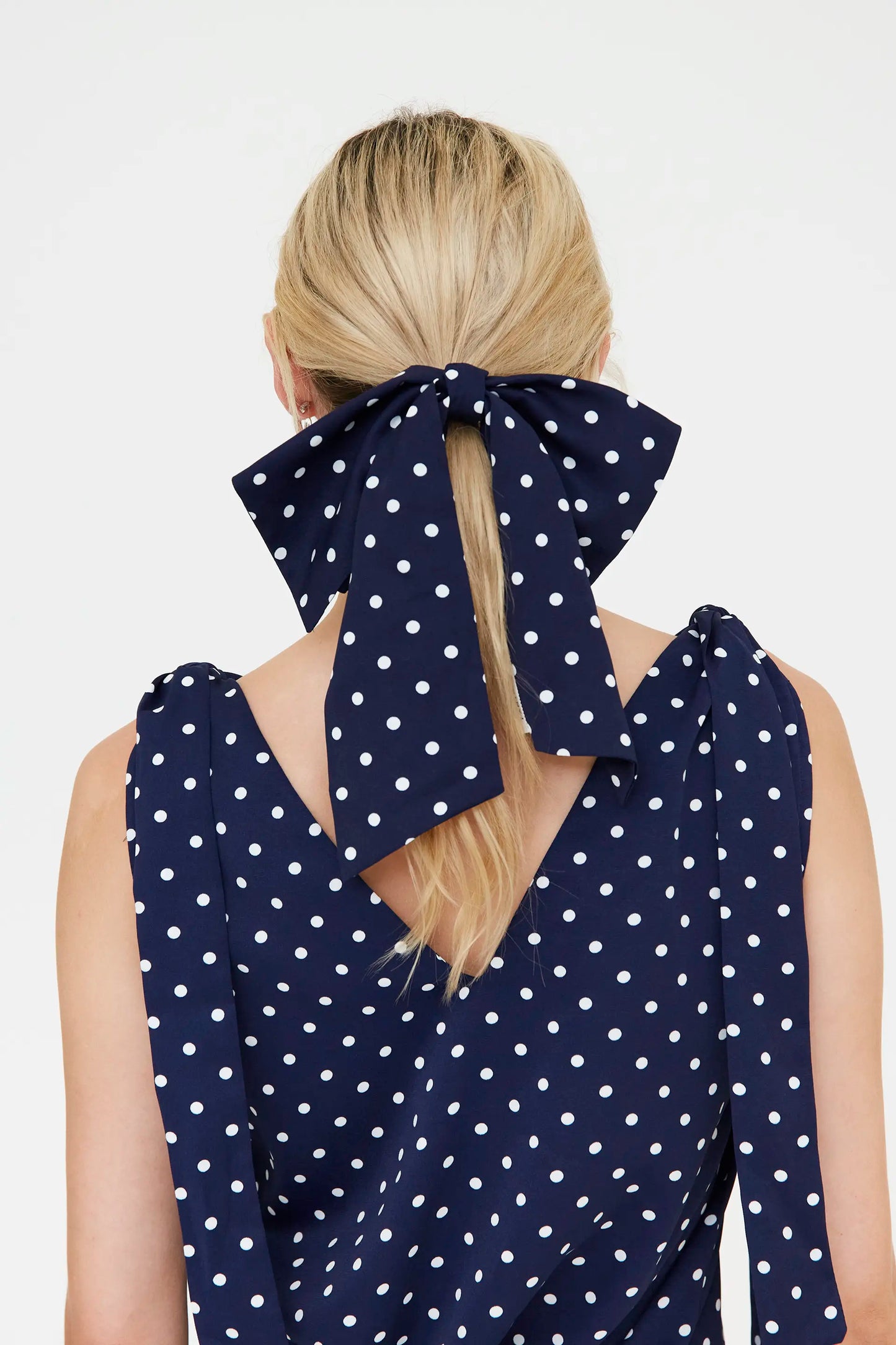 Navy blue bow scrunchie with white mini polka dot print