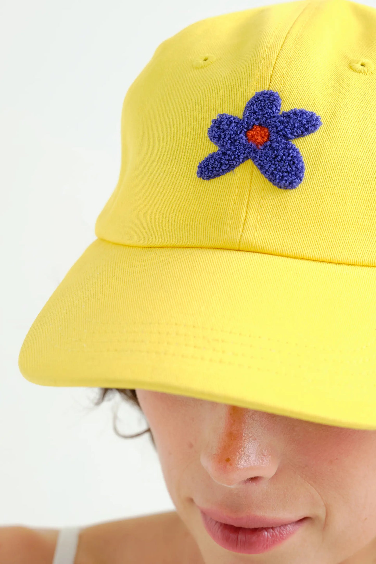 Yellow cap with blue flower embroidery