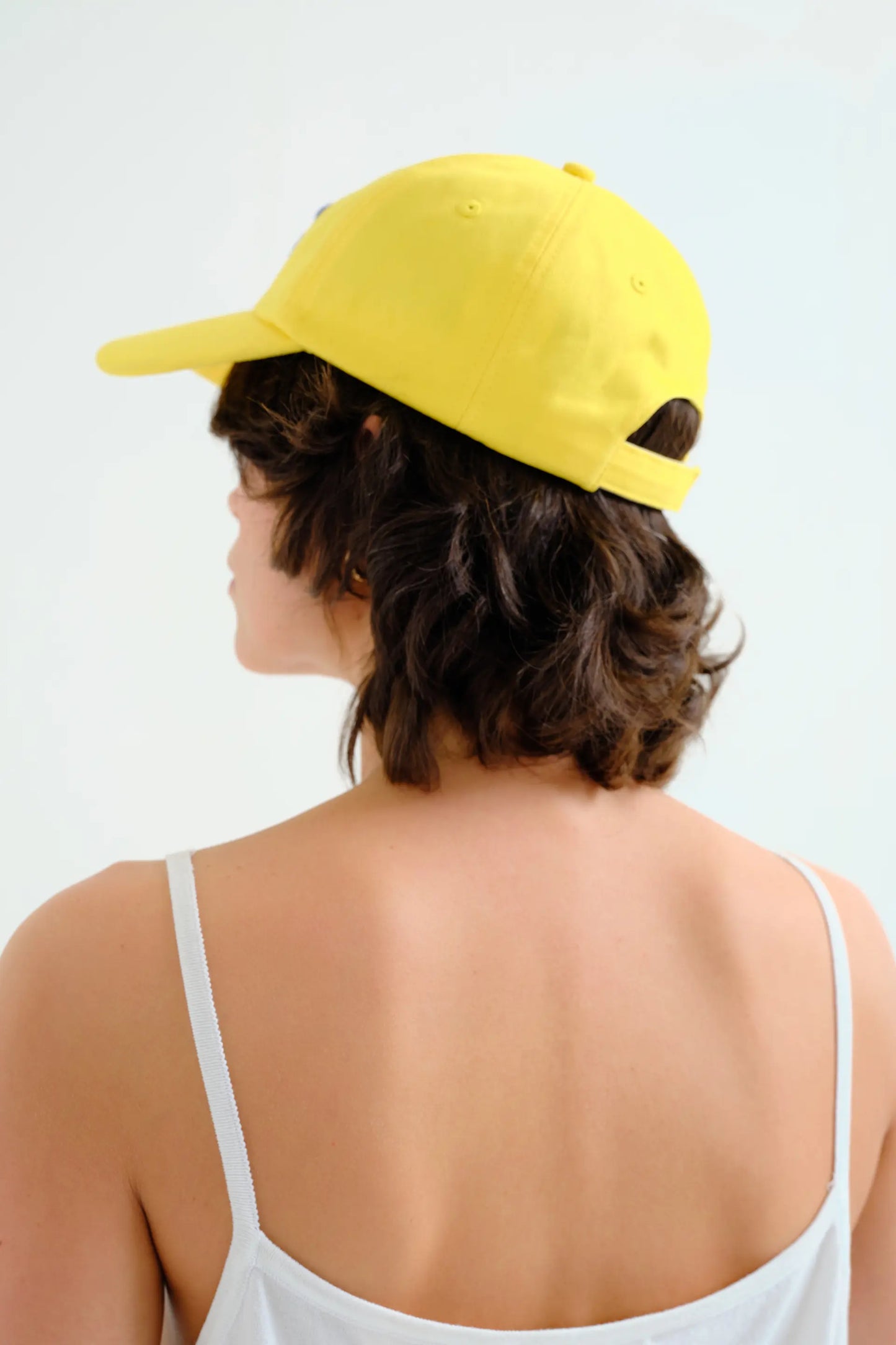 Yellow cap with blue flower embroidery
