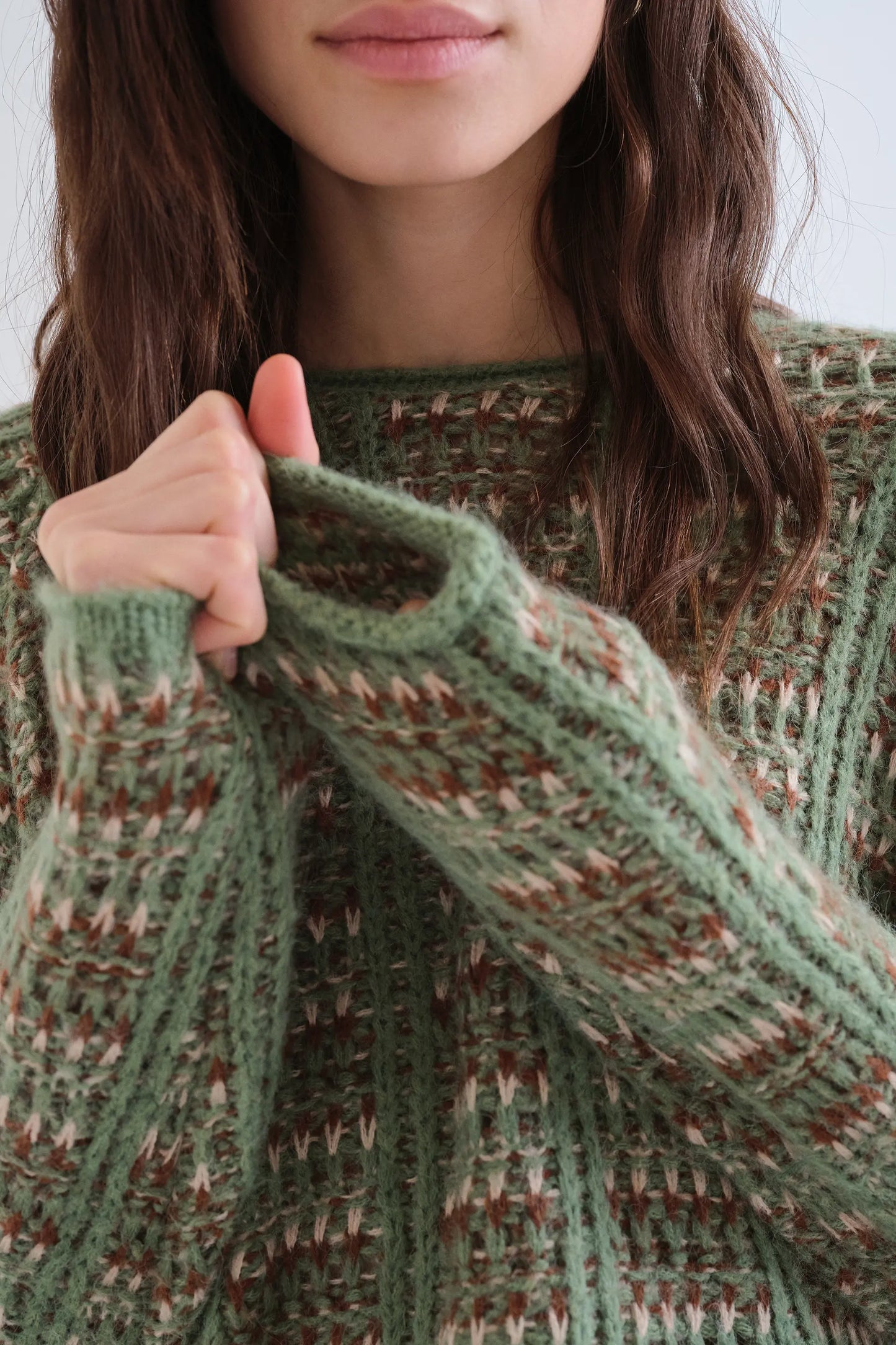 Green knitted jumper with embroidered details