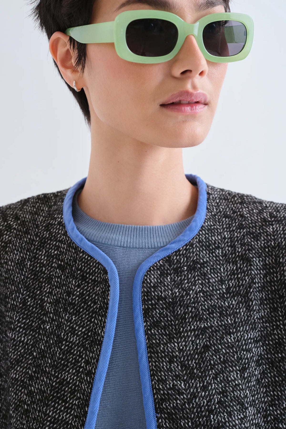 Chaqueta tweed negra con detalles azul claro