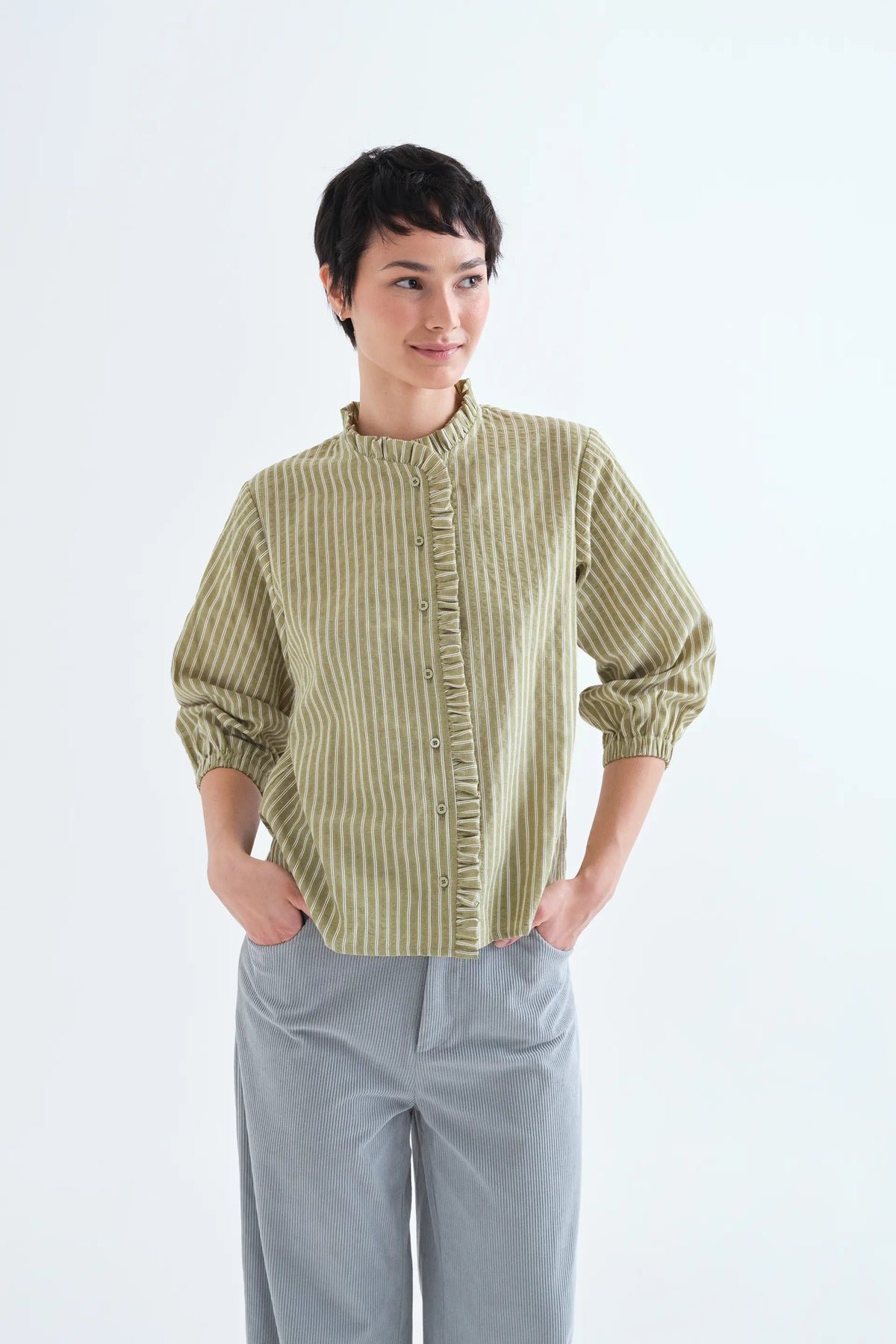 Light green striped shirt with ruffle detail