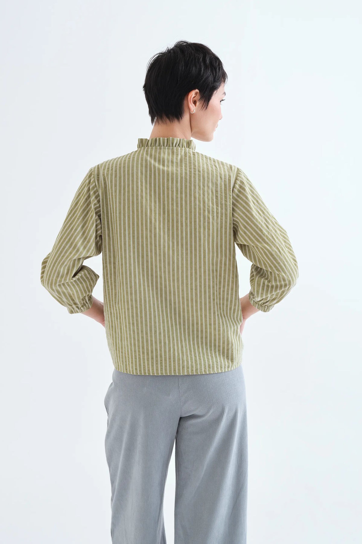 Light green striped shirt with ruffle detail