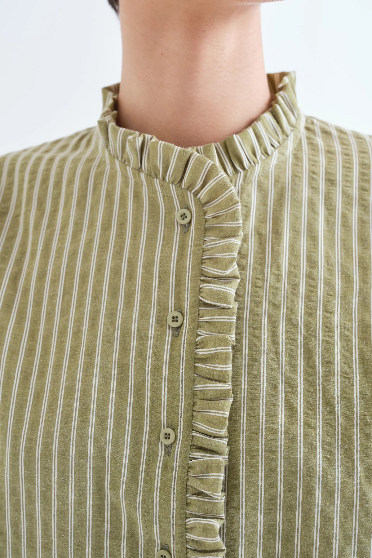 Light green striped shirt with ruffle detail